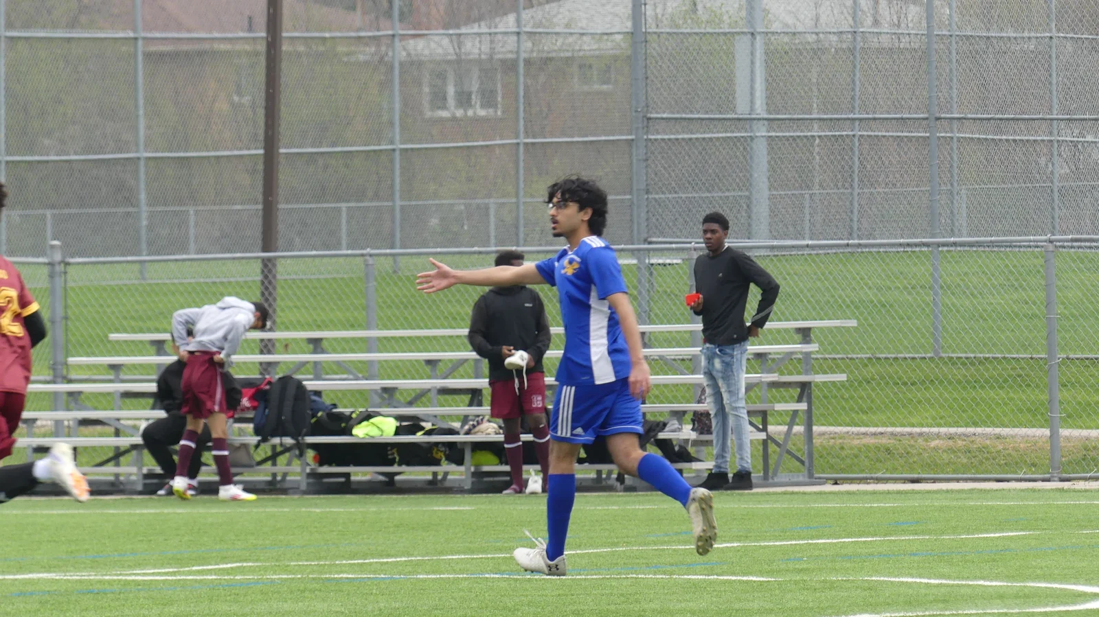 On the pitch in a blue football kit
