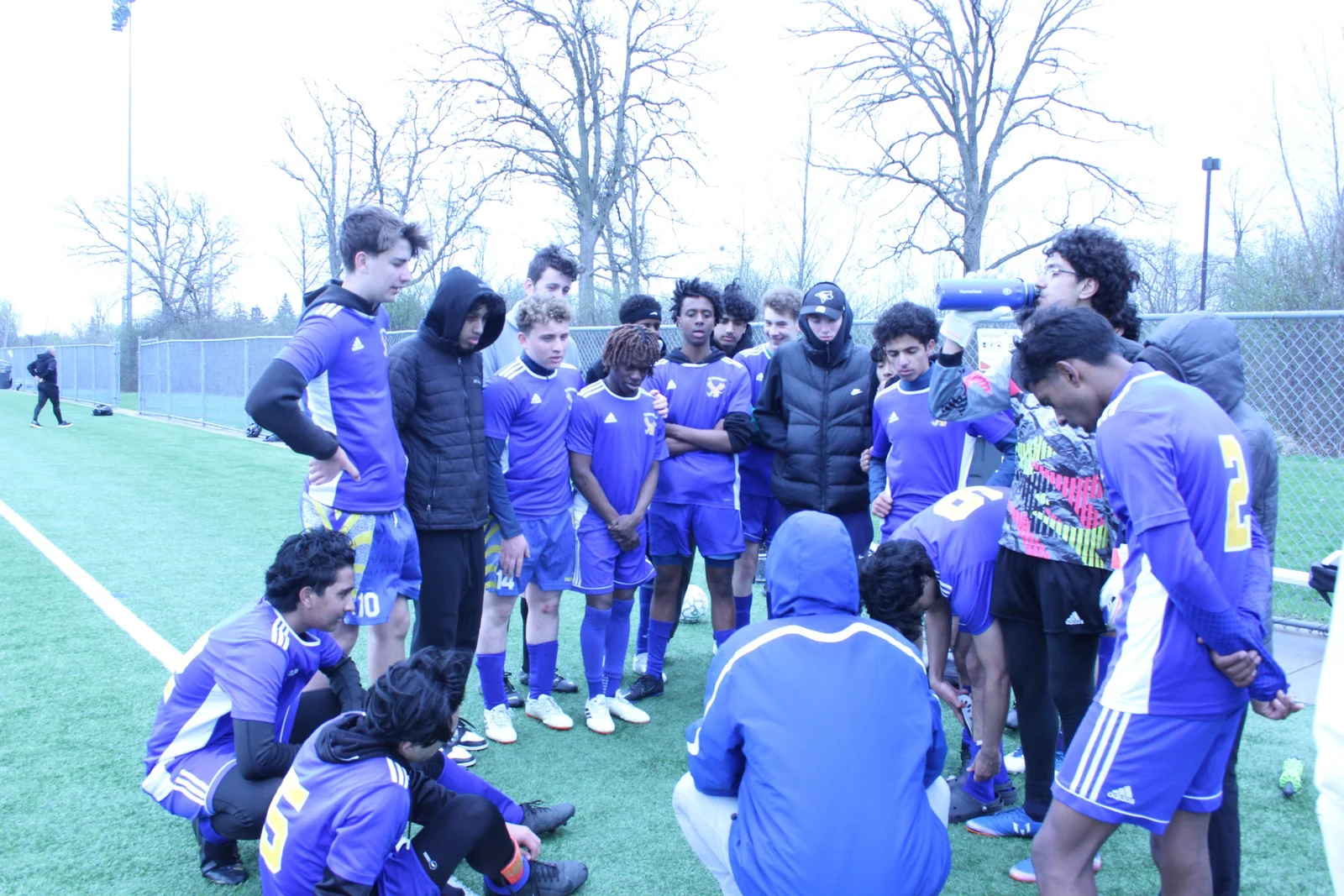 A team huddle beside the pitch